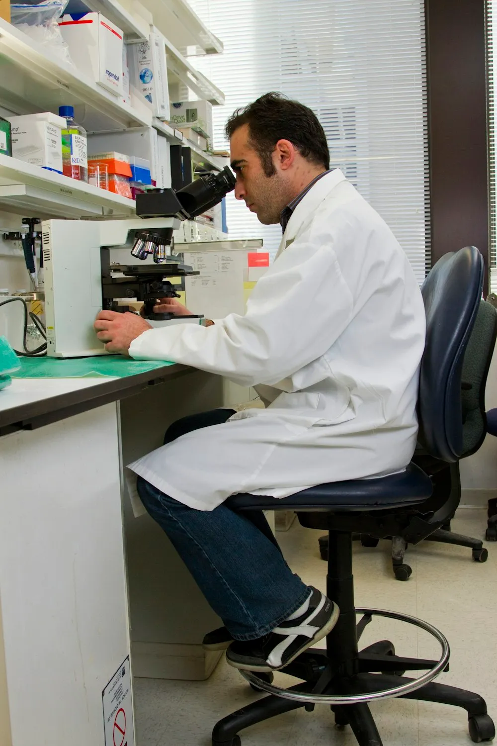 Scientist using a microscope
