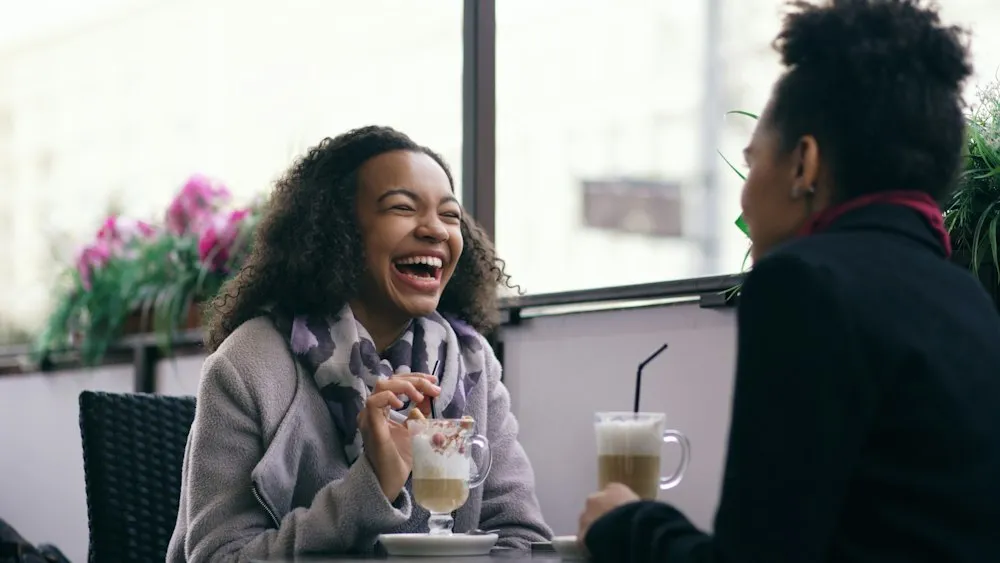 Friends laughing in a cafe