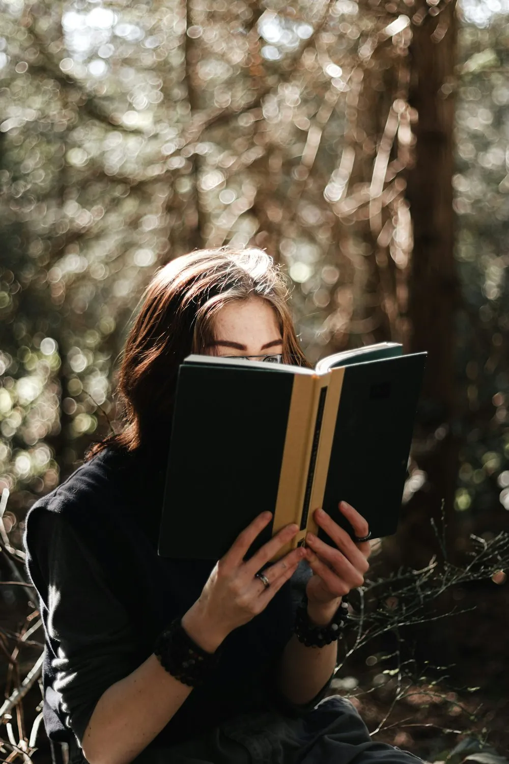 Woman absorbed in an interesting book outdoors