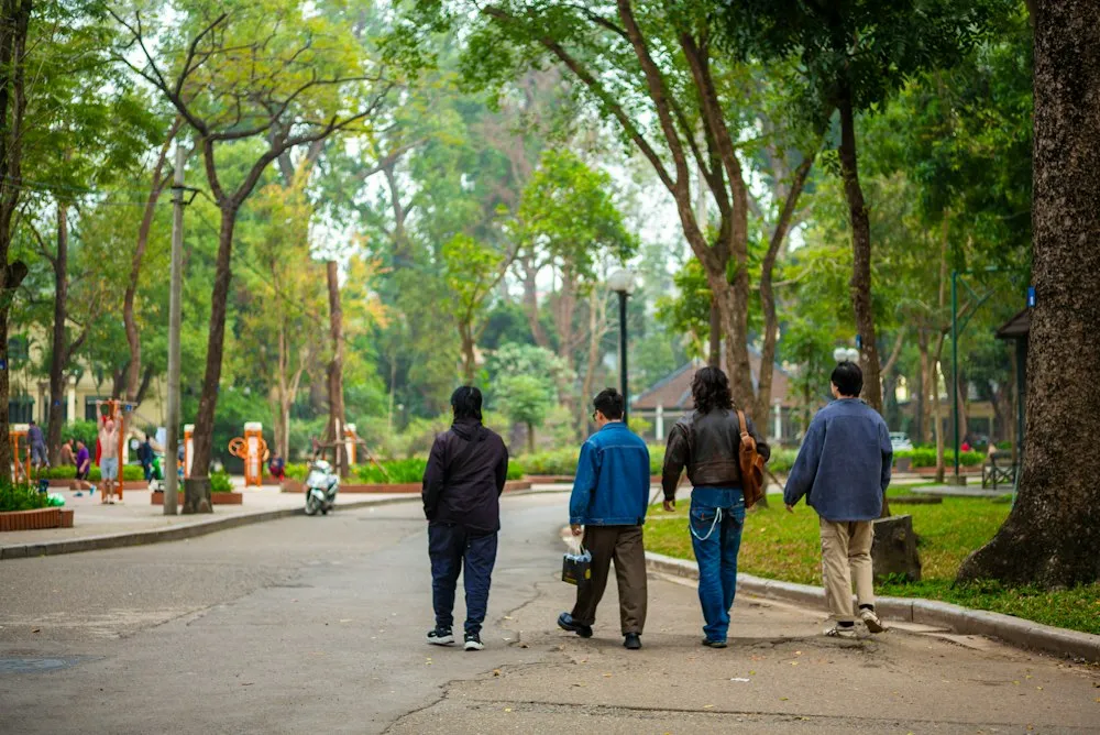 A group of people walking away down a path