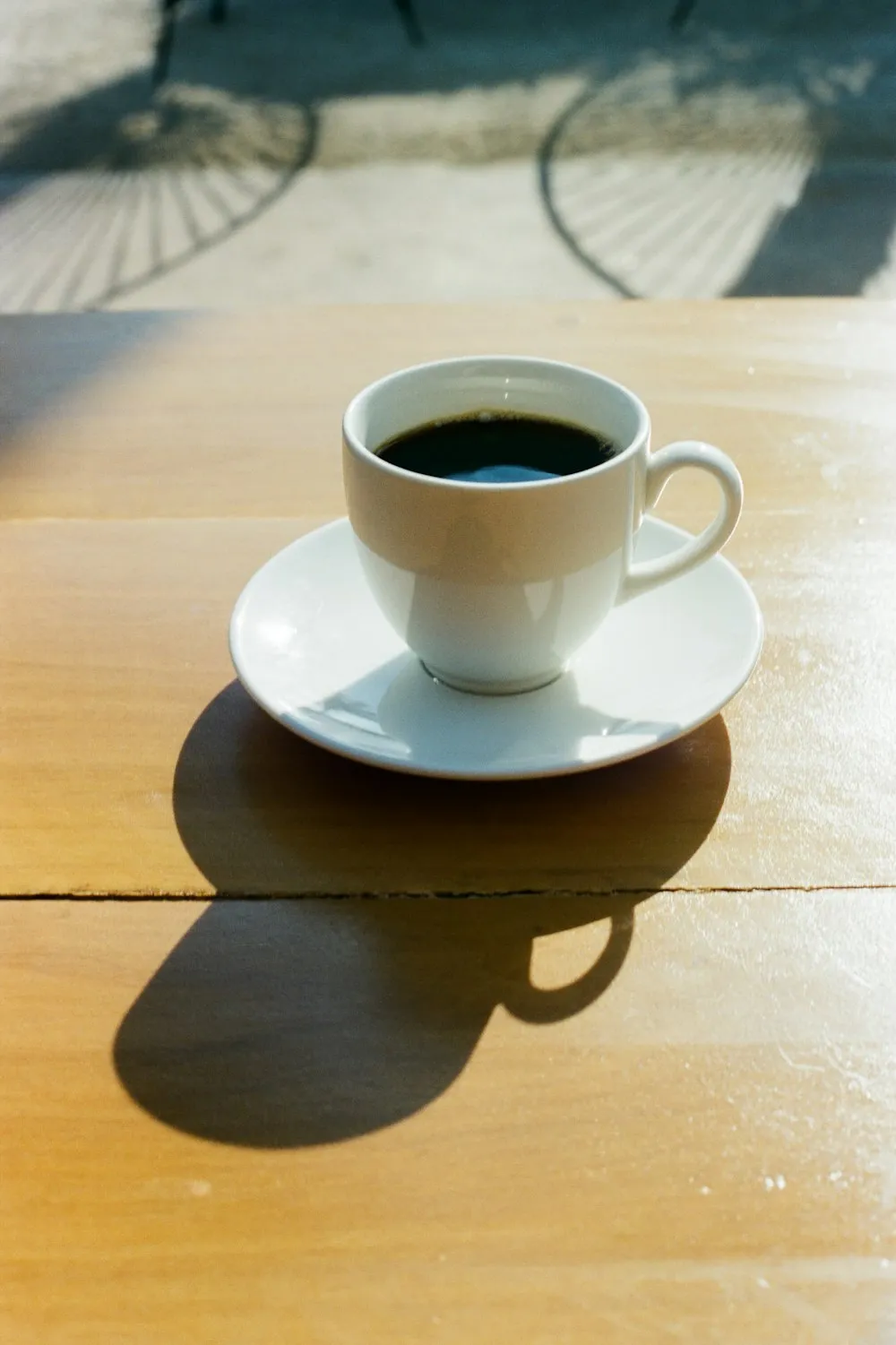 A cup of black coffee on a wooden table
