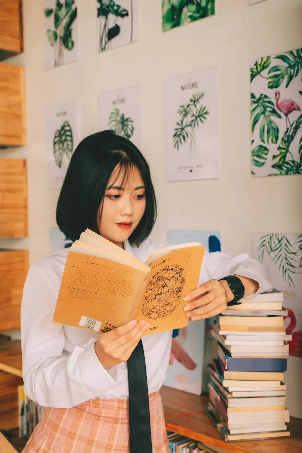Woman studying an open book at a desk