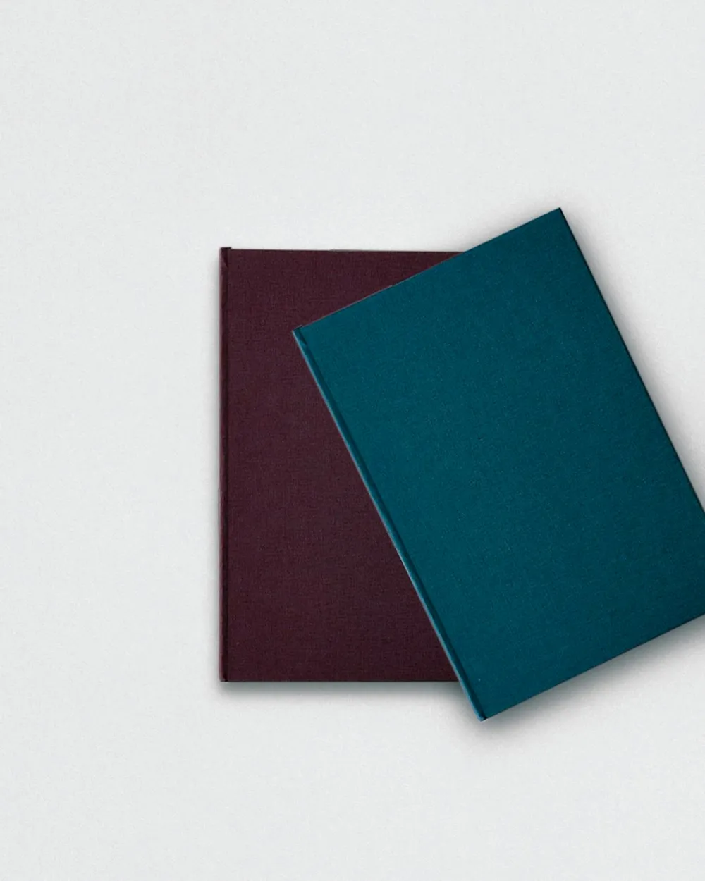 Exactly two hardcover books stacked on a table