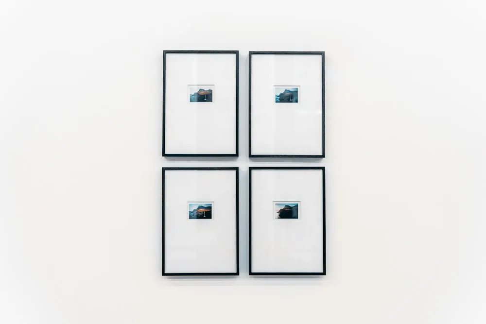 Framed pictures mounted on a white wall