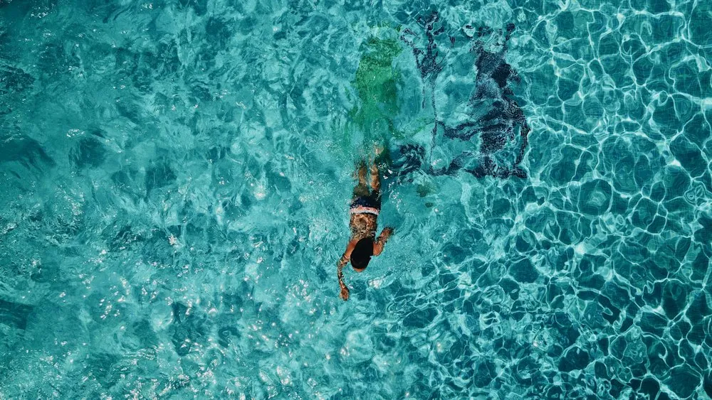 A person swimming in clear turquoise water
