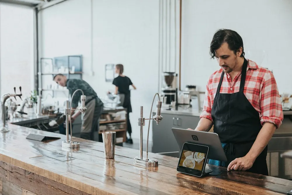Barista serving at a coffee shop counter