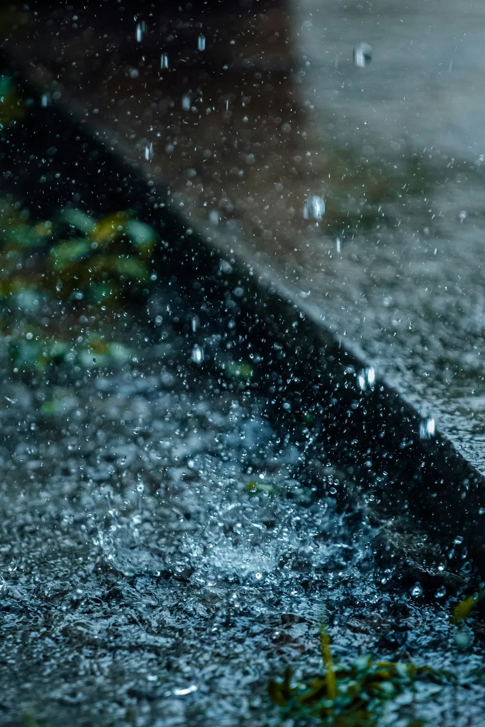 Heavy rain splashing on wet concrete